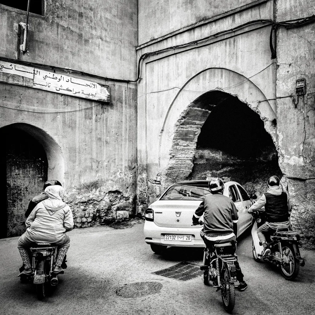 Schwarzweißfotografie einer alten, verwitterten Gasse mit historischen Gebäuden